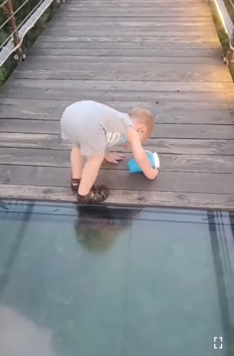 【1億再生超え】ガラス張りのつり橋を渡ろうとした男の子。慎重に足を踏み入れたが、下を見てある決断をしました